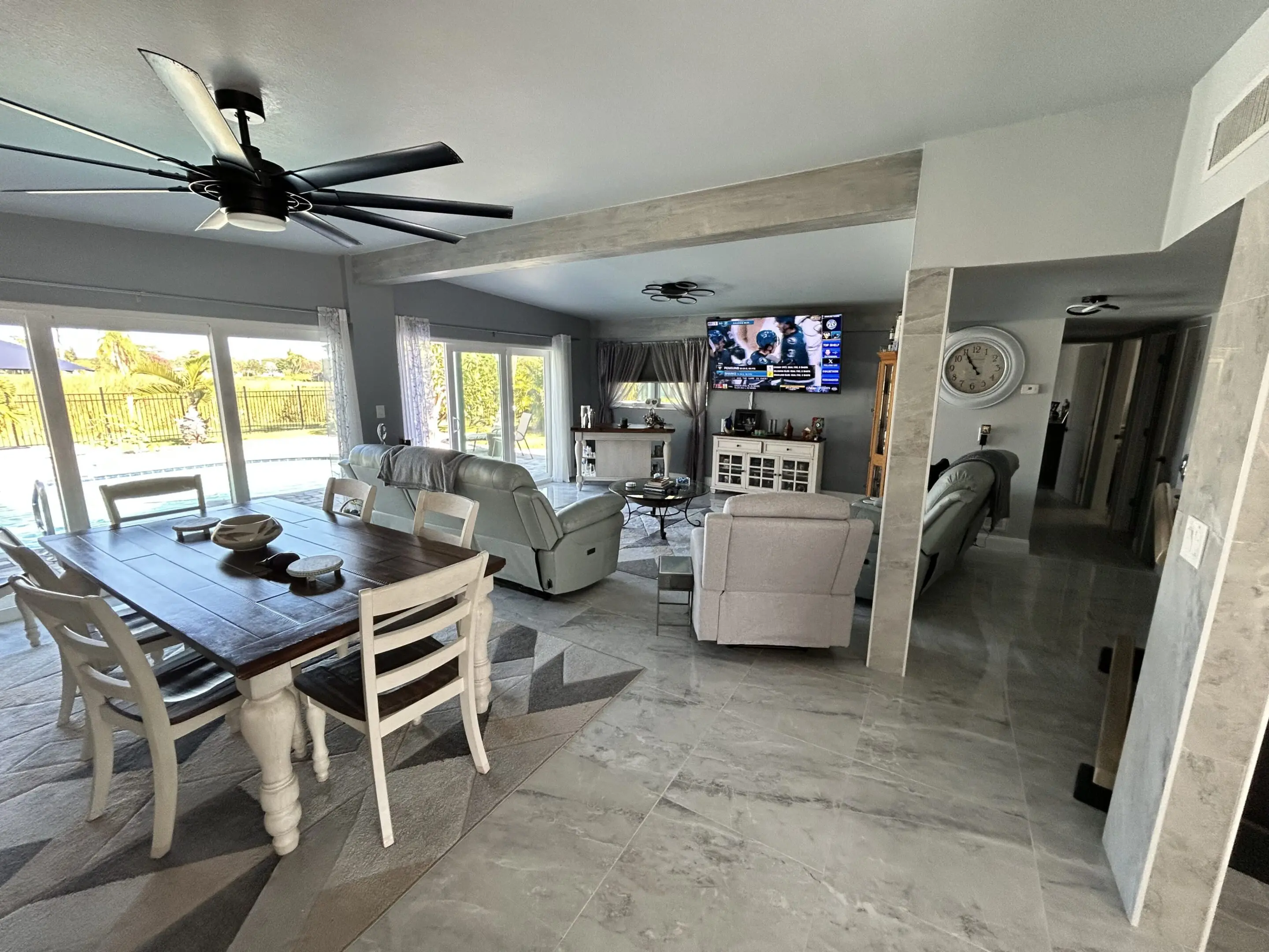 Bright, modern living and dining area with large windows and neutral decor.